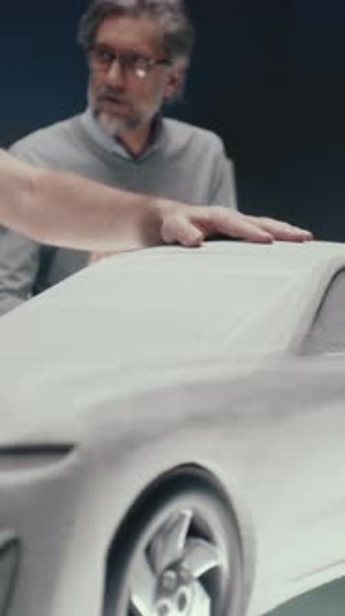Car Designers Working on Model in Studio