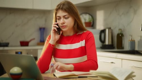 At a Remote Job a Woman Works Efficiently at Home on a Laptop