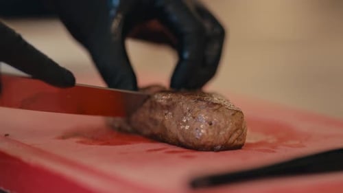 Chef hand cut delicious steak meat, close up view