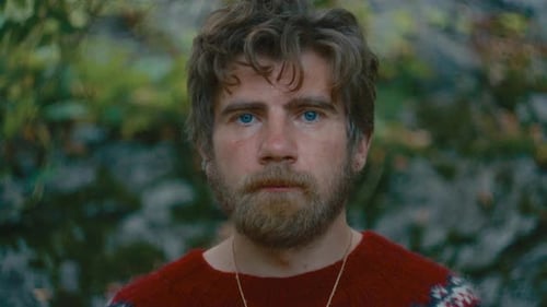 Portrait of Bearded Man in Red Sweater Standing in Forest
