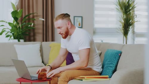 Man Working on Laptop Computer from Home