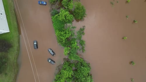Flooded Neighborhood Showing Submerged Cars and Homes