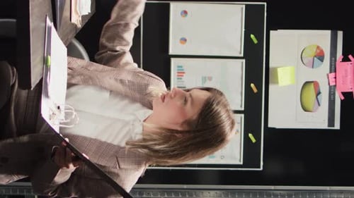 Young Woman Reviews Business Documents in Office