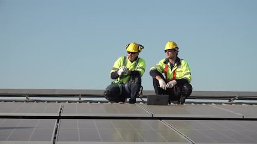 Solar energy and an engineering team on the roof of a building to install panel. Rooftop Solar cell.