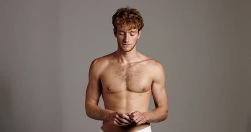 Face, cologne and man in studio, cosmetics and confident person on gray background