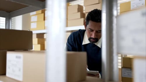 Warehouse workers checking inventory on shelves using tablet, ensuring stock accuracy