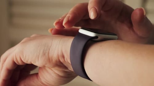 Woman Using Smartwatch with Dark Purple Band