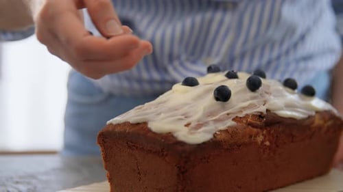 Food Cooking and People Concept - Close Up of Woman Decorating Cake