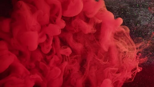 Vibrant Red Ink Swirling in Slow Motion