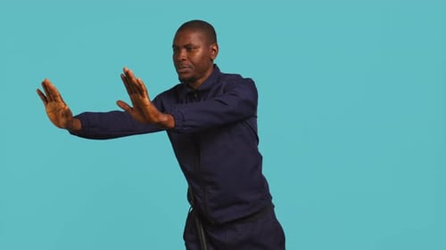 Man Gesturing Stop with Hands in Studio