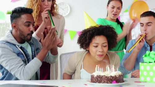 Friends Celebrate Birthday with Cake and Party Blowers