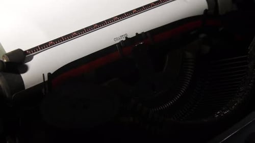 Old Typewriter Typing Chapter Title on White Paper