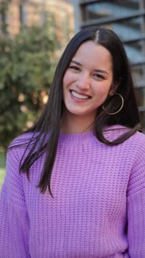 Smiling Brunette Woman in Purple Sweater Outdoors