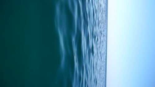 Vertical Aerial View on Sea Water Surface Camera Flies Over Clear Sea Water Sun Glare Abstract