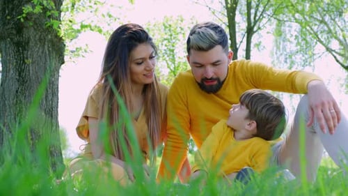 Loving Family Relaxing Together in Spring Park