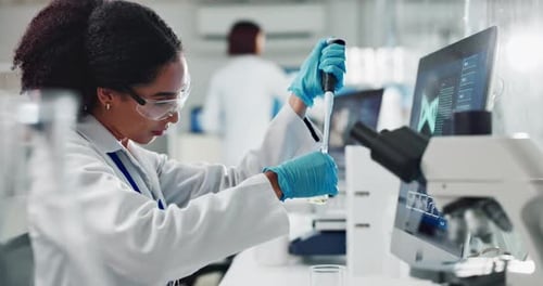 Woman Scientist Working with Pipette in Laboratory