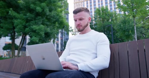 Businessman Play Computer In City