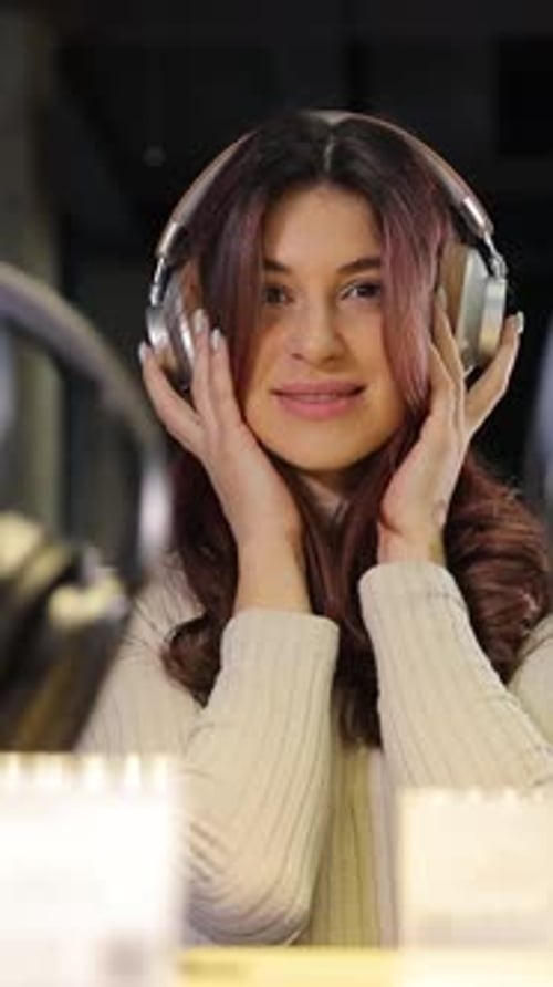 Woman Testing Headphones in an Electronics Store Vertical Video
