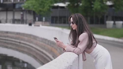 Stylish Middleaged Business Woman Writes SMS in Summer