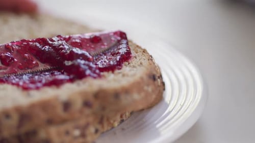 Jelly is spread across bread