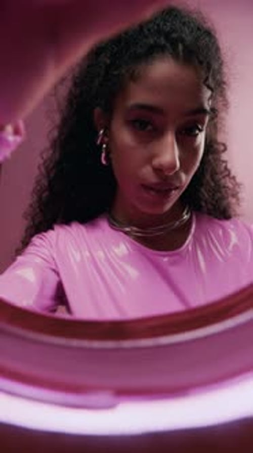 Woman Holding Pink Ring Posing Indoors
