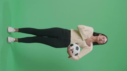 Full Body Of Asian Woman With A Ball Putting Hand On Her Heart To Respect On Green Screen