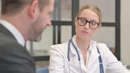 Close up of Female Doctor Talking with Male Patient