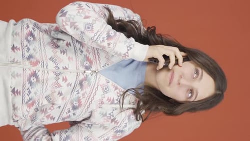 Young Adult Woman Smiling and Talking on Phone