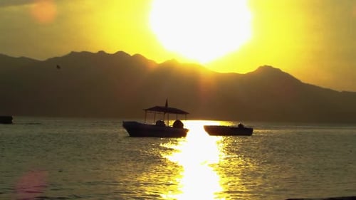 Romantic View of the Sunset with Speed Boat and Jet Ski in the Background