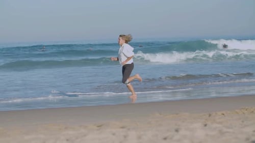 Confident Woman Running at Fast Pace on Sandy Beach