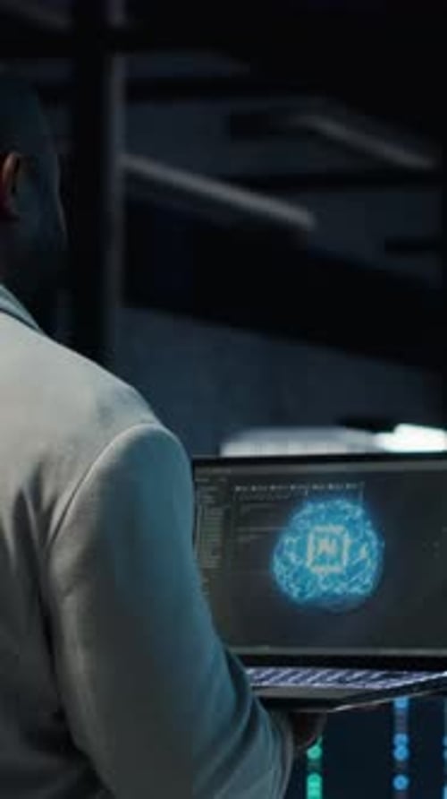 Vertical Video IT Expert Walking in Server Hub Using Laptop to Enhance AI Model Accuracy