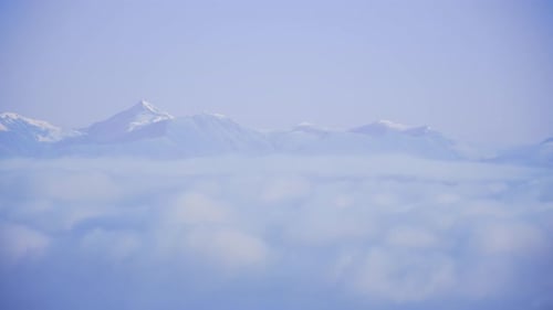 Snowy Mountains Above a Sea of Clouds