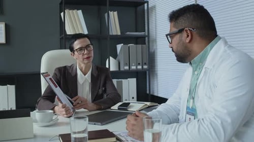 Doctors Discussing Medical Data in Office