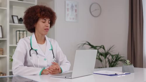 Female Doctor on Video Call with Laptop