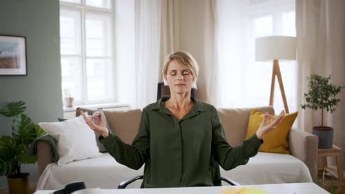 Portrait of Business Woman Indoors in Office Doing Yoga at Desk, Mental