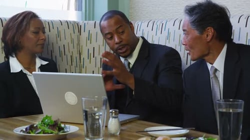 Group Of Business People Having Meeting In Restaurant