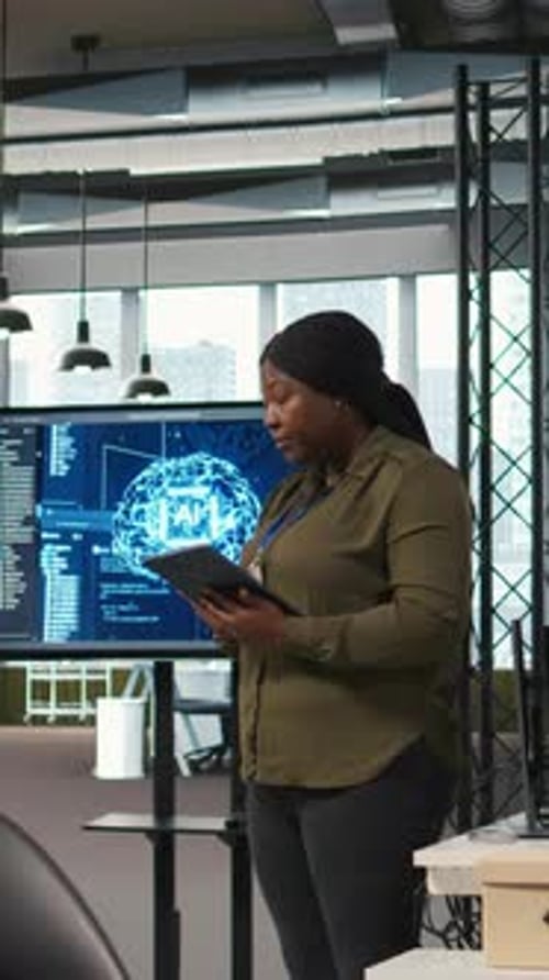 Vertical Video Female Programmer Coding AI Algorithms on Tablet to Debug Software Issues