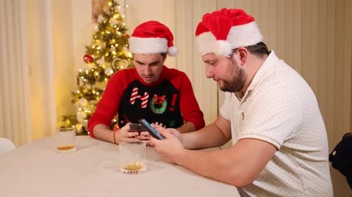 couple d'amis antisociaux, membres de la famille portant un chapeau de Père Noël célébrant les vacances de Noël