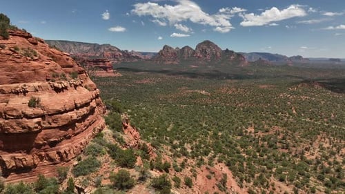 Mountainscape Reveal Of Red Rocks And Green Forest In Sedona, Arizona, Aerial View