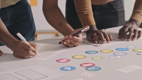 Team of Mobile App Developers Drawing Sketches