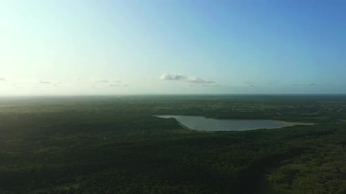 Grass, landscape and drone in nature with lake, water and blue sky in environment at summer