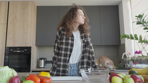 Thoughtful Woman Looking Through Window In Home Kitchen Interior