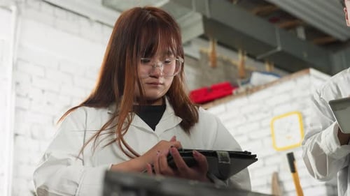 Lab Students Take Notes on Tablets in Automotive Workshop
