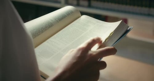 Jeune fille autodidacte lisant un livre dans une bibliothèque, les mains d'une femme, tenant un livre ouvert, apprenant à étudier