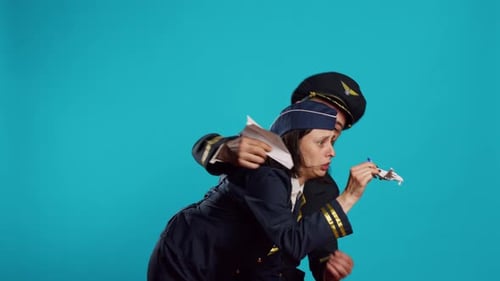 Couple of Aviators Playing with Toy and Paper Airplane