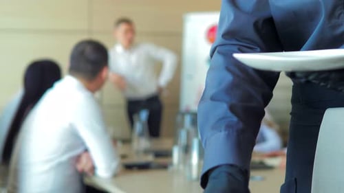Waiter Serving Food to a Corporate Meeting