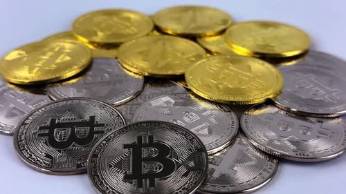 Gold and Silver Bitcoins Spinning in Close Up
