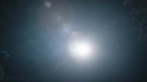 Creepy Masked Figure Exploring in the Dark
