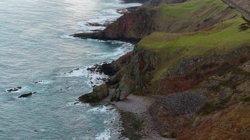 Stormy Seaside with Waves Crashing on Steep Cliffs and Rocky Shore Wild Ocean Surf Pounding Rugged