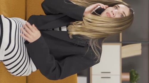 Smiling Woman Talking on Phone Lying on Couch